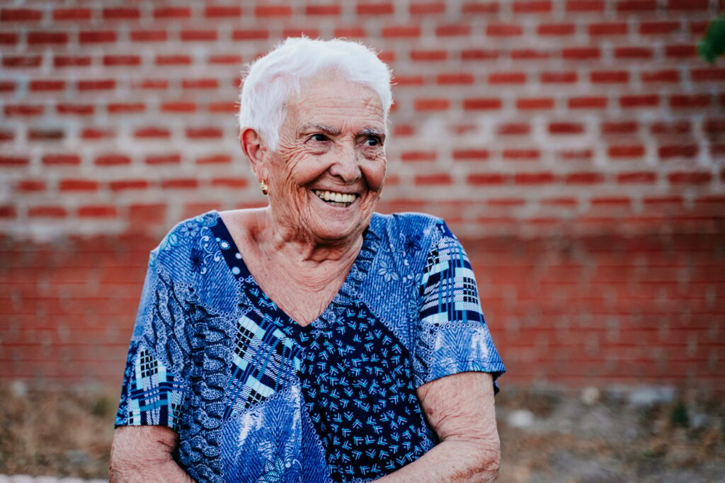 portrait of old lady in her 80s laughing happily